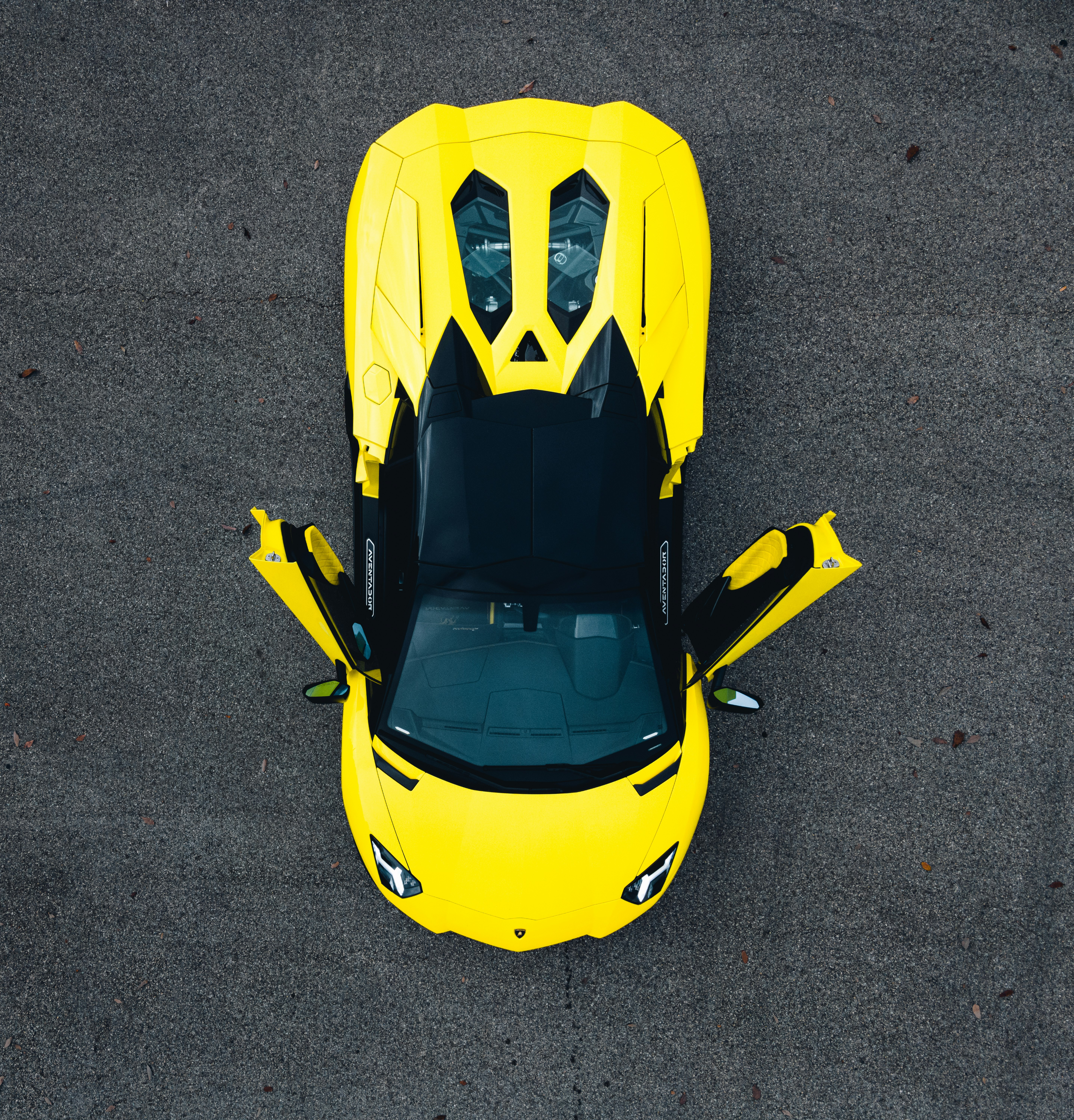 yellow and black car on gray asphalt road